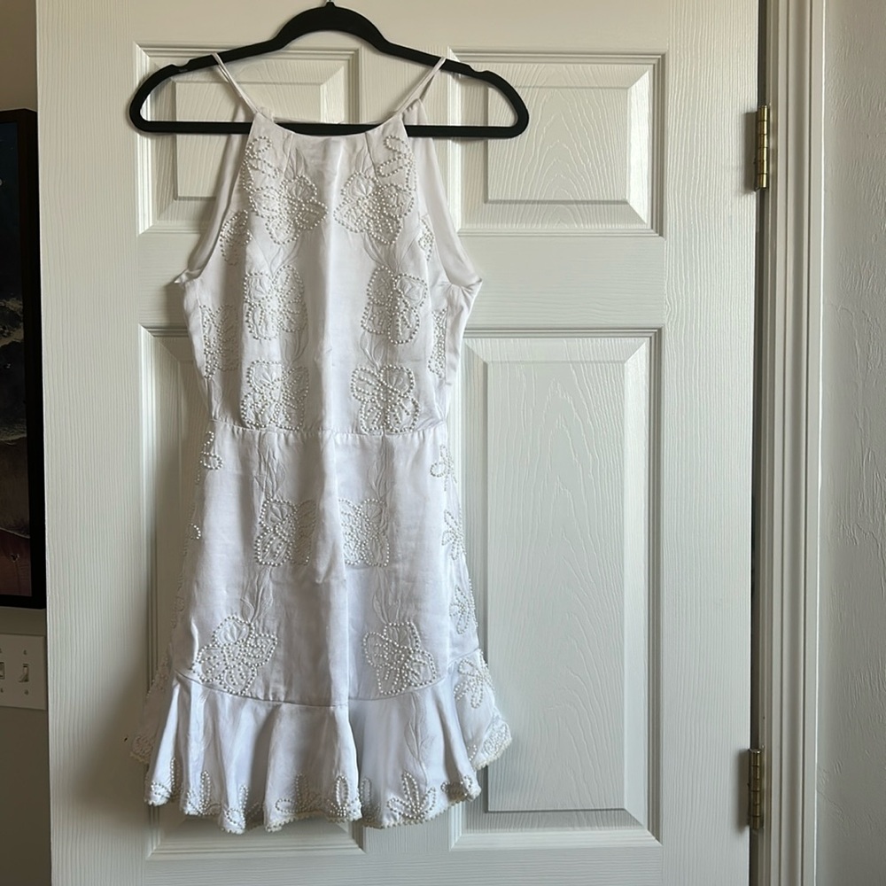 White beaded mini dress by Karina Grimaldi
